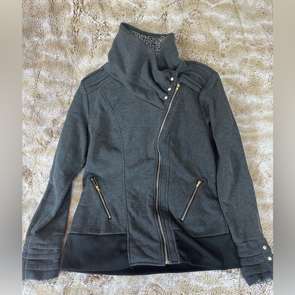 Light jacket, sweatshirt material with zipper and button detail.